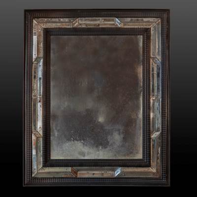 An important double frame ebonised mirror, small lateral mirrors in perspective effect, North of Italy, 18th century (114cm high, 94 cm wide, 6 cm deep) (45 in. high, 37 in. wide, 3 in. deep)